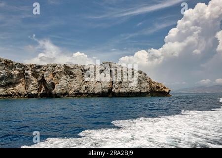 Felsenformation mit Gischt und dramatischen Wolken Foto Stock