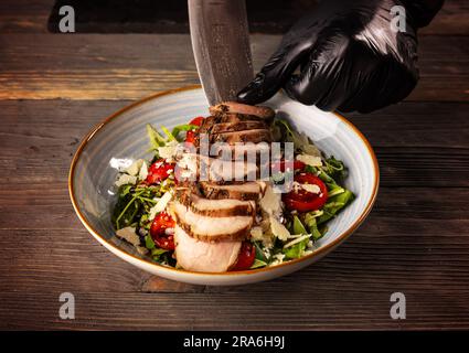 Insalata è pronta per essere servita. Lo Chef ding ultima seconda decorazione. Foto Stock