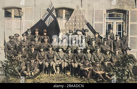 Un gruppo di ufficiali britannici e americani fotografò in un campo di addestramento non divulgato nel 1917, con le bandiere britanniche e statunitensi puntellate in modo prominente dietro di loro. Data: 1917 Foto Stock