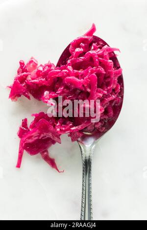 Barbabietola rosa brillante e crauti di cavolo su un cucchiaio grande. Foto Stock