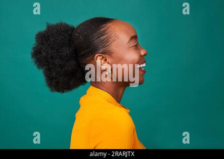 Profilo di Beautiful Black Woman, sfondo ottanio, ritratto di moda Foto Stock