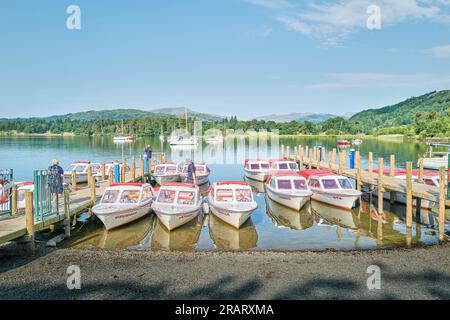 Piccole barche a motore ormeggiate da moli sul lago Windermere, Waterhead, Lake District, Cumbria, Inghilterra. Foto Stock