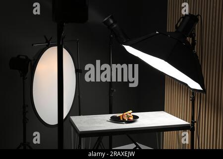 Composizione con pollo al forno, pastinaca e fragole su tavolo grigio in studio fotografico professionale. Fotografia di cibo Foto Stock