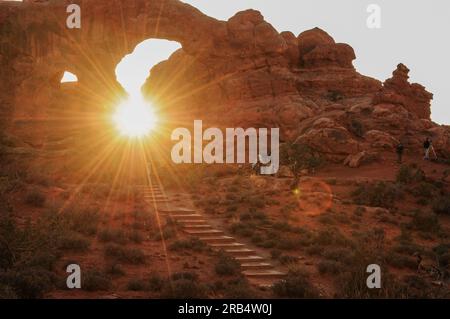 Il tramonto sbircia attraverso il Window Arch nell'Arches National Park, Utah, Stati Uniti Foto Stock