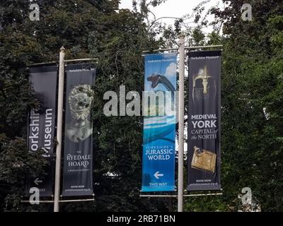 YORK, Regno Unito - 3 LUGLIO 2023: Insegne presso i Giardini del Museo di York per le attrazioni dei Toristi - Yorkshire Museum, Ryedale Hoard, Jurassic World e Medieval Y Foto Stock