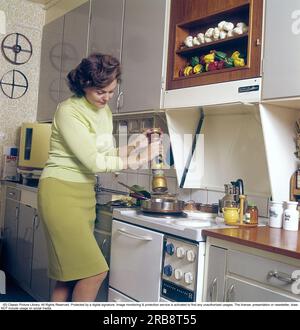Haide Göransson (1928-2008) attore e modella svedese. Qui a casa, in cucina, dove sta vicino alla stufa e cucina, nell'angolo c'è una lavastoviglie rotonda del marchio electrolux, chiamata anche lattina rotonda, qualcosa che è facile da capire perché la lavastoviglie ha la strana forma rotonda. Svezia 1968. Kristoffersson Foto Stock