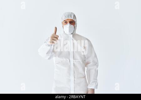 Medico in tuta medica protettiva mostrando pollici su. Concetto di successo Foto Stock