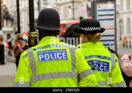 Londra, Inghilterra, Regno Unito - 27 giugno 2023: Due agenti di polizia della Metropolitan Police in pattuglia nel centro di Londra. Foto Stock