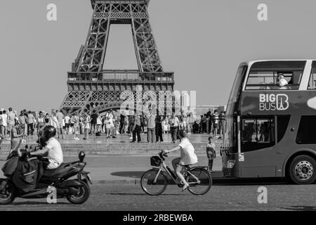 Parigi, Francia - 25 giugno 2023: Veduta dell'affollata piazza del Trocadero, con autobus, bicicletta e moto che passano davanti alla Torre Eiffel a Parigi Foto Stock