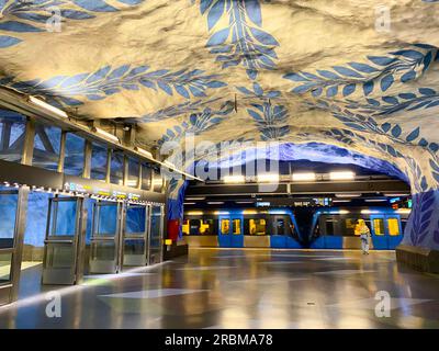 Stoccolma, Svezia - 11 giugno 2023, stazione della metropolitana T-Centralen (linea blu, stazione centrale) con scala mobile e pareti bianche con motivi blu, ce Foto Stock