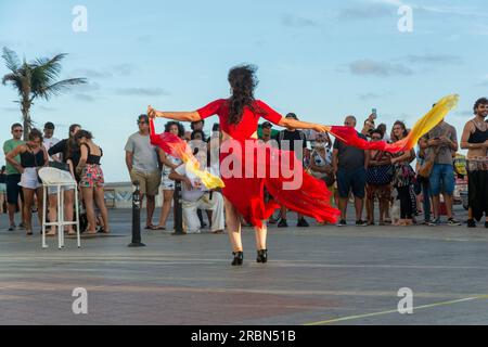 Salvador, Bahia, Brasile - 22 ottobre 2022: Artista di strada che fa una performance di danza per molte persone a Farol da barra, a Salvador, Bahia. Foto Stock