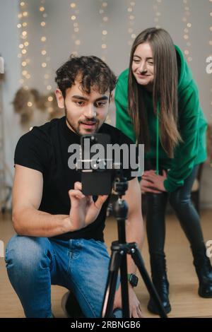 Un uomo e una ragazza adorabili che fanno un live streaming mentre ballano balli popolari online. Foto Stock