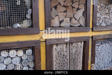 Hotel per insetti con molti fori e diversi tipi di legno Foto Stock