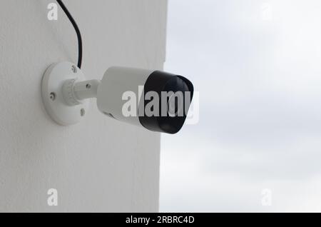 Telecamera di sicurezza posizionata sul portico, per tenere d'occhio eventuali attività sospette. Occhio vigile che protegge 24 ore al giorno. Tranquillità e tranquillità Foto Stock