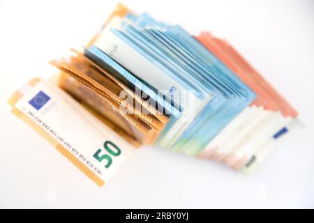 Diverse banconote in euro giacciono su sfondo bianco, con spazio per le copie. Immagine concettuale, crisi, potere d'acquisto, inflazione, risparmi, spese. Foto Stock