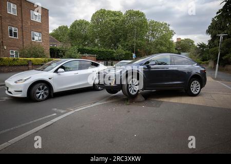 Tesla rimane intrappolata dopo aver guidato accidentalmente su un dissuasore stradale all'angolo di una strada residenziale a South Wimbledon, Londra, Inghilterra, Regno Unito Foto Stock