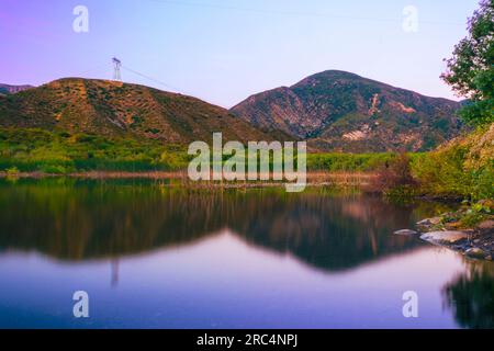 Immergiti nella tranquillità, mentre Lost Lake riflette le affascinanti montagne di San Bernardino e la drammatica faglia di San Andreas all'ora d'oro Foto Stock