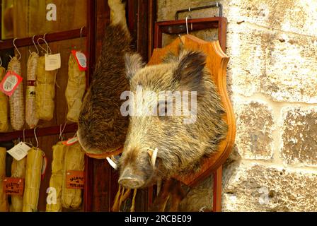 Testa di cinghiale ripiena (Sus scrofa) presso il banco delle salsicce, San Gimignano, Toscana, cinghiale, Italia Foto Stock