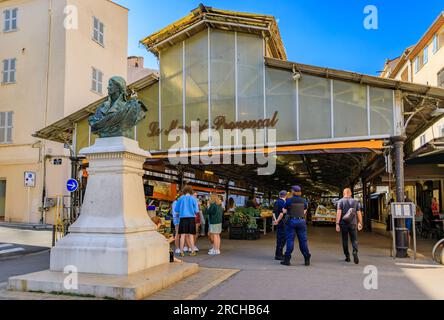 Antibes, Francia - 24 maggio 2023: Sala del mercato provenzale coperto a Cours Massena nel centro storico di Vieil Antibes, negozi in entrata e polizia all'esterno Foto Stock