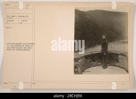 Pvt. W.W. Faulkner della Quartier generale Co. 5th Marines sta di guardia su un vecchio ponte di pietra sul fiume Wied ad AltWied, in Germania. La foto è stata scattata da Pvt. Ray P. Antrim il 27 marzo 1919. A questa immagine viene assegnata la descrizione "E00" e il numero di pubblicazione "A4959". Foto Stock