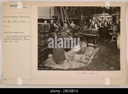 Lavoratori che gestiscono una macchina a vite manuale nello stabilimento di fusione della Bartlett-Hayward Co. A Baltimora, Maryland, nel 1918. La fotografia cattura l'attività di produzione di munizioni durante la prima guerra mondiale Foto Stock
