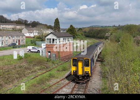 Classe 150 DMU train150270 che passa il segnale della staffa meccanica del quadrante inferiore e la scatola di segnale a Tondu, Galles del sud, Regno Unito Foto Stock