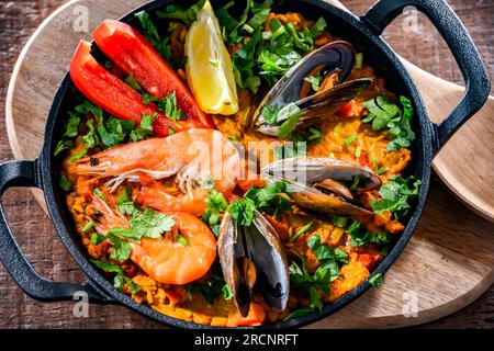 Paella di pesce servita in una padella di ghisa. Foto Stock