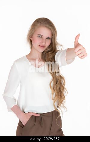 Ritratto della felicità giovane donna bionda che mostra i pollici in alto e guarda la fotocamera. Espressione etnia caucasica donna d'affari ben vestita Foto Stock