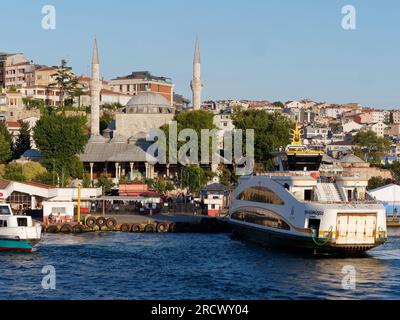 Il traghetto passeggeri è attraccato a Uskudar sul Bosforo con la moschea del sultano Mihrimah alle spalle. Lato asiatico di Istanbul, Turchia Foto Stock