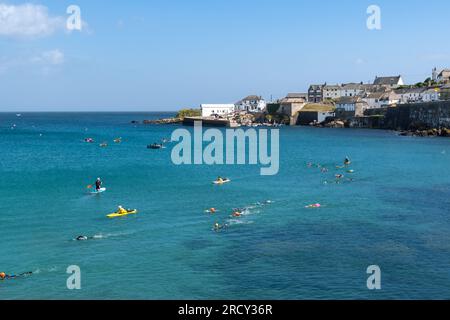 COVERACK, CORNOVAGLIA, REGNO UNITO - 1° LUGLIO 2023. Un'attività organizzata di nuoto in acqua selvaggia con nuoto in mare aperto a Coverack in Cornovaglia Foto Stock