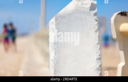 Post informativo in pietra bianca senza iscrizioni. Pilastro di pietra sul molo. La superficie per l'iscrizione. Foto Stock