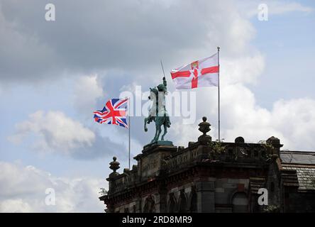 Bandiere che volano accanto alla statua equestre di re Guglielmo III nell'edificio Orange Hall a Belfast Foto Stock