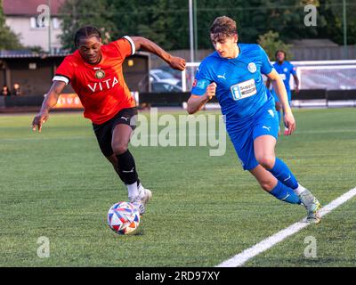 Il giocatore di Warrington Rylands corre lungo l'ala sinistra inseguito da un difensore dello Stockport Town allo Stockport Sports Village su un campo 3G. Foto Stock