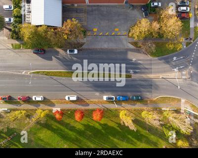 Vista aerea delle auto parcheggiate lungo una strada divisa fiancheggiata da alberi autunnali a Castlemaine nel Victoria centrale, Australia Foto Stock