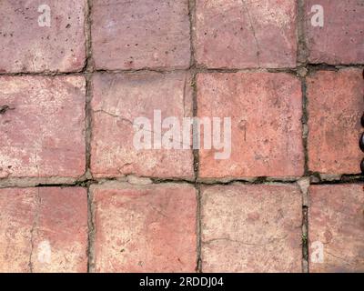 Fotografia ravvicinata di vecchie e rustiche piastrelle di argilla su un pavimento stagionato di una fattoria vicino alla città coloniale di Villa de Leyva, nella Colombia centrale. Foto Stock