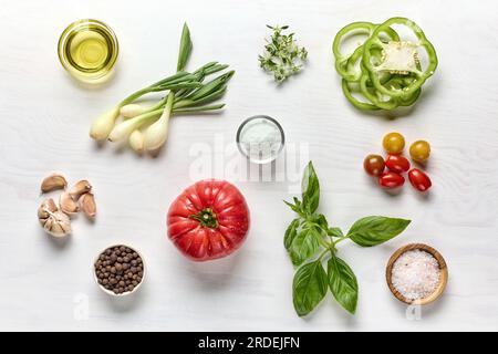 varie verdure, erbe e spezie su un tavolo di legno bianco, vista dall'alto Foto Stock