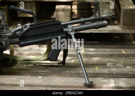 airsoft weapon m60, l'arma nera sul pavimento si erge su bipodi Foto Stock