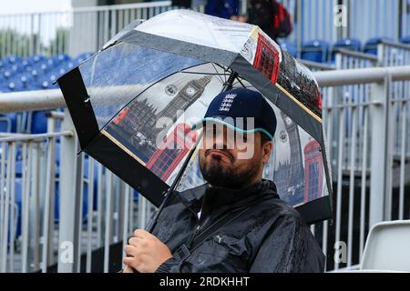 Manchester, Regno Unito. 22 luglio 2023. Tifoso di cricket che guarda infuocato mentre si ripara dalla pioggia davanti al LV= Insurance Ashes test Series Fourth test Day Four Match Inghilterra vs Australia a Old Trafford, Manchester, Regno Unito, 22 luglio 2023 (foto di Conor Molloy/News Images) a Manchester, Regno Unito il 22/7/2023. (Foto di Conor Molloy/News Images/Sipa USA) credito: SIPA USA/Alamy Live News Foto Stock