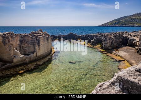 Le incredibili piscine naturali di Marina Serra, in Puglia, Salento, Tricase. Il mare turchese limpido e cristallino, tra la scogliera rocciosa. Il cielo blu Foto Stock