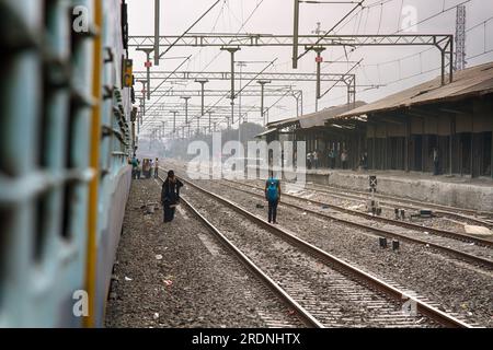 India, Pune - 6 aprile 2018: Situazione abituale per le stazioni ferroviarie indiane. le persone non sono sicure a camminare sui binari della ferrovia Foto Stock