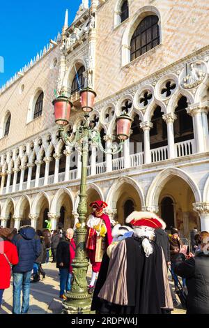Spettacolari costumi di persone mascherate e turisti che si divertono in Piazza San Marco durante le celebrazioni del Carnevale di Venezia Foto Stock