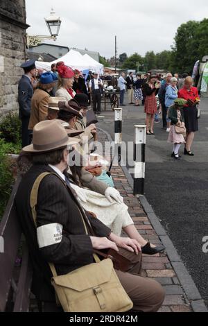 I visitatori, alcuni vestiti in abiti anni '1940, si godono la giornata fuori al Severn Valley Railway, il giorno degli anni '1940. Foto Stock