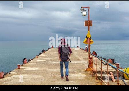 Viaggiatore sul bordo di una scogliera nel mare Foto Stock