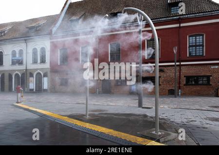 Installazione per raffreddare le persone spruzzando acqua sopra di esse. Su una piazza nella città lituana di Kaunas. Attenzione alla contaminazione da Legionella Foto Stock