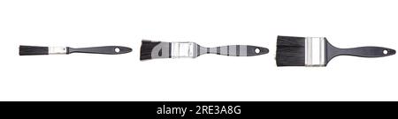 Set di spazzole per vernice nuovo pulito con manico in legno nero isolato su sfondo bianco. Foto Stock