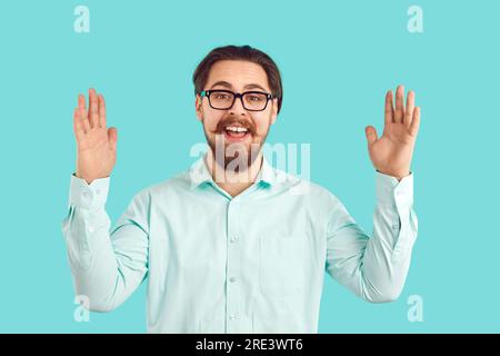 Felice divertente eccitato giovane nerd in camicia e occhiali che mostra quanto è grande qualcosa Foto Stock