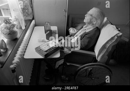 Anziani Care Casa 1970S.. Donna disabile in sedia a rotelle da sola e che ascolta la radio wireless a transistor portatile. Ricordi che forse ricordano il passato.70 Inghilterra 1972 UK HOMER SYKES Foto Stock