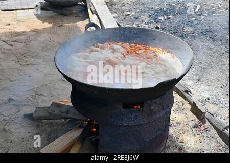 Per la conservazione, i gamberetti vengono cotti in grandi teglie di wok, dopo di che vengono essiccati su tavoli di essiccazione lang Foto Stock