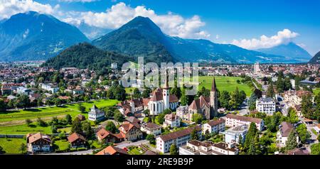 Vista aerea sulla città di Interlaken in Svizzera. Splendida vista della città di Interlaken, Eiger, Monch e Jungfrau montagne e del lago Thun e Fr Foto Stock