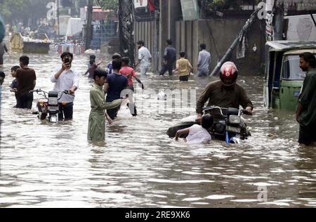 Hyderabad, Pakistan , 26 luglio 2023, i pendolari stanno affrontando difficoltà di trasporto a causa dell'acqua piovana stagnante a causa di un sistema fognario scarso causato dalla pesante discesa della stagione dei monsoni, a Lakshmi Chowk a Lahore mercoledì 26 luglio 2023. Foto Stock